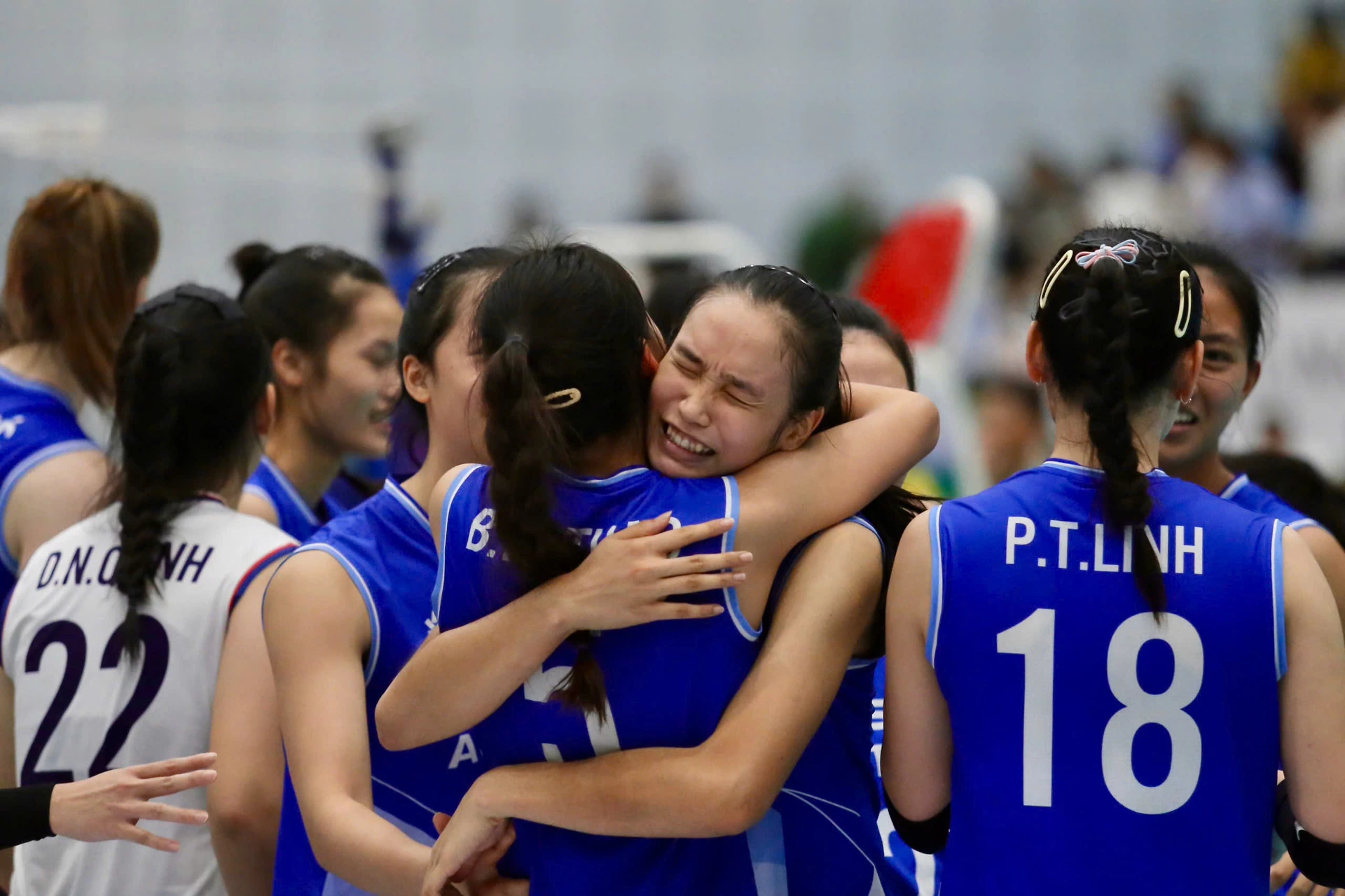Hanoi Tasco Auto women players in blue jerseys hug and celebrate on court after their semifinal