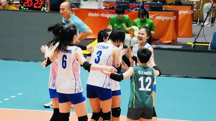 Archive photo of Vietnam women’s volleyball players celebrating on court.