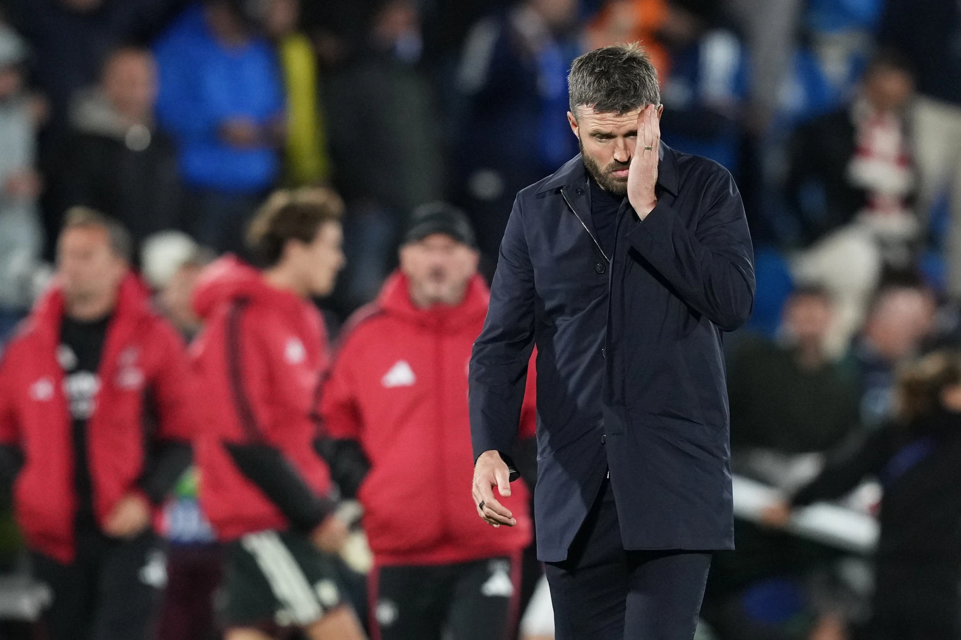 Manchester United manager Michael Carrick covers half of his face with his hand after the 4-1 defeat by Como.