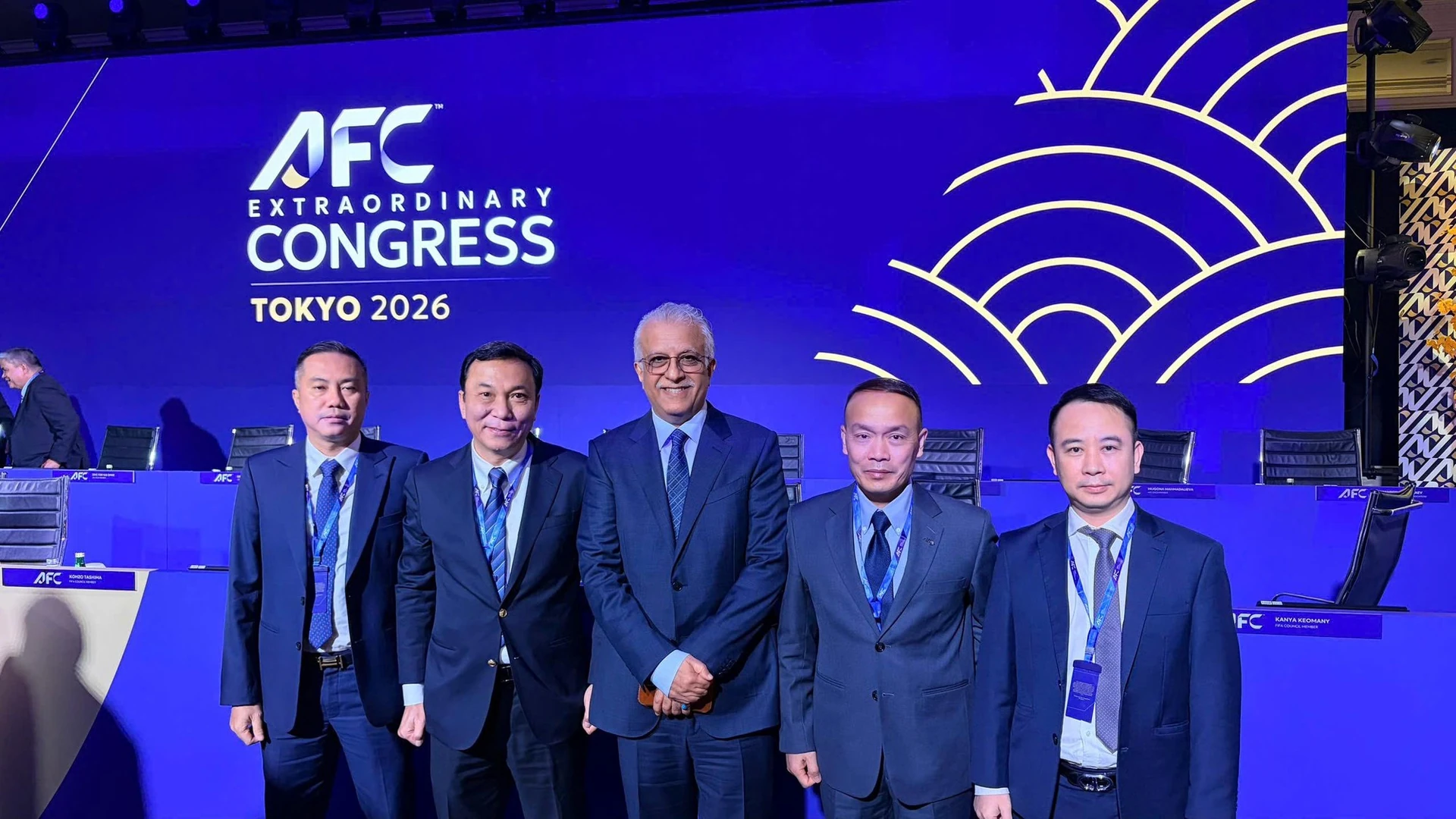 Five men in suits pose for a photo in front of the AFC Extraordinary Congress Tokyo 2026 backdrop.