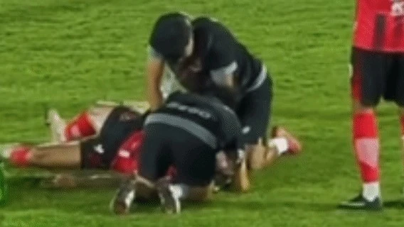 Medical staff perform CPR on player Wasusiwakit Phusirit lying unconscious on the pitch