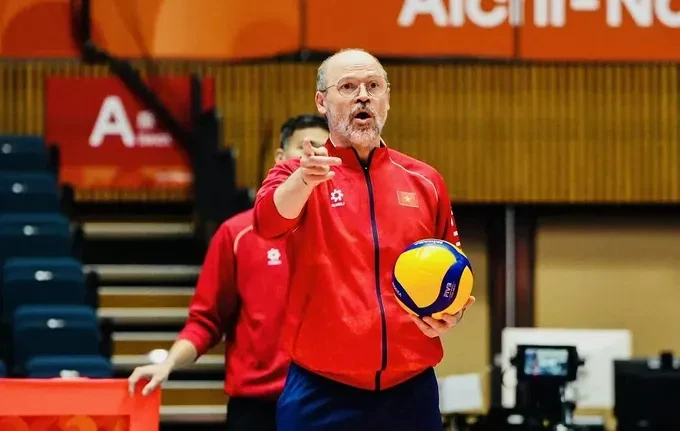 Federico Rampazzo instructs players in an archive Vietnam volleyball photograph.