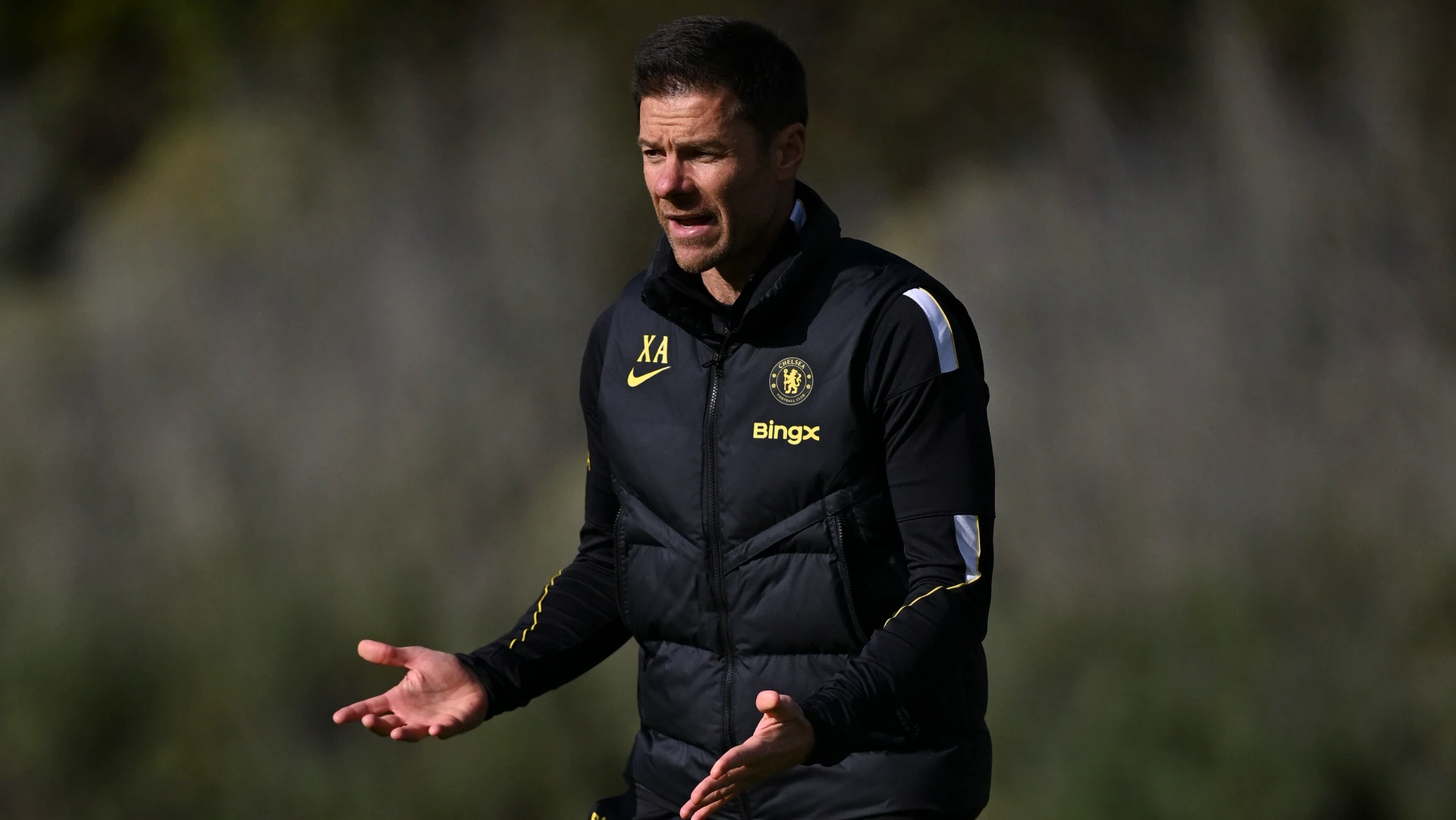File photo: head coach Xabi Alonso in a black Chelsea gilet gestures with both hands while giving instructions at a training ground.