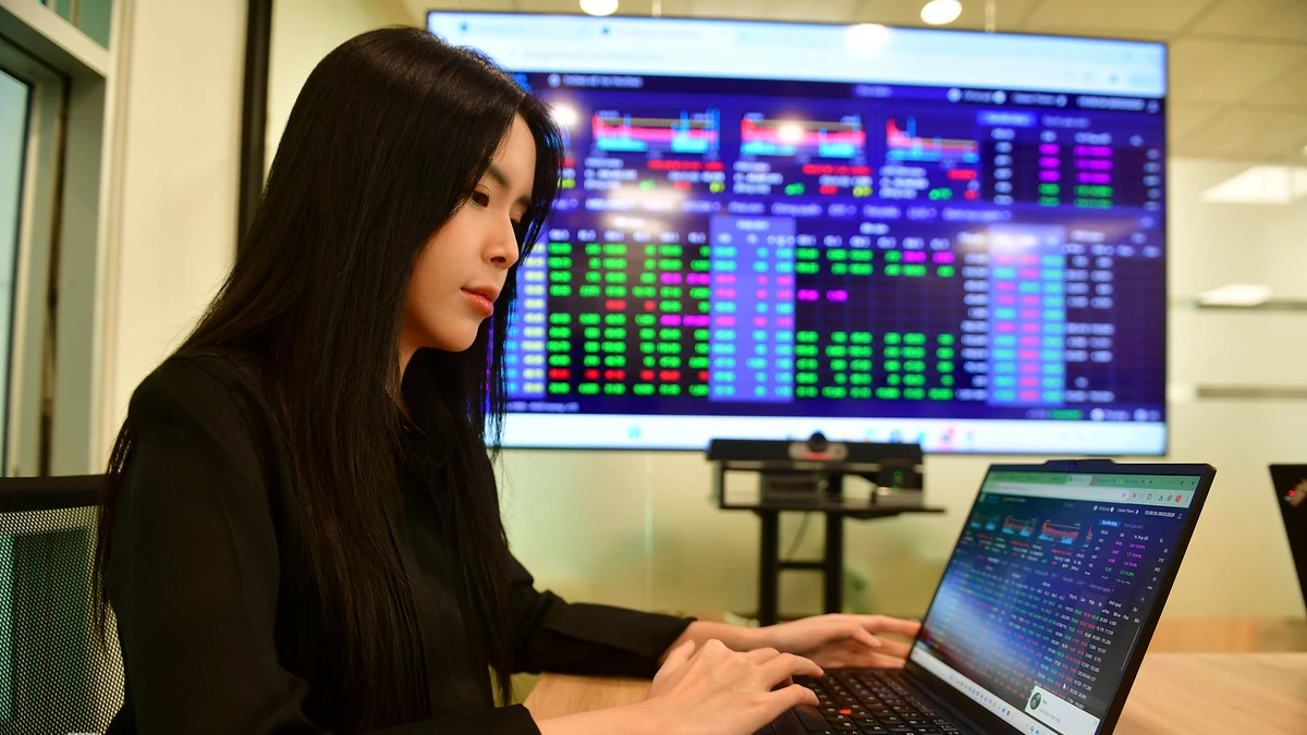 Một nhà đầu tư theo dõi bảng giá chứng khoán trong ảnh tư liệu.