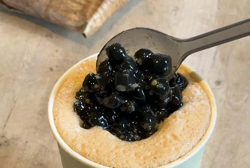 A plastic spoon in a frame from a Phe La drinks video from August 2026.
