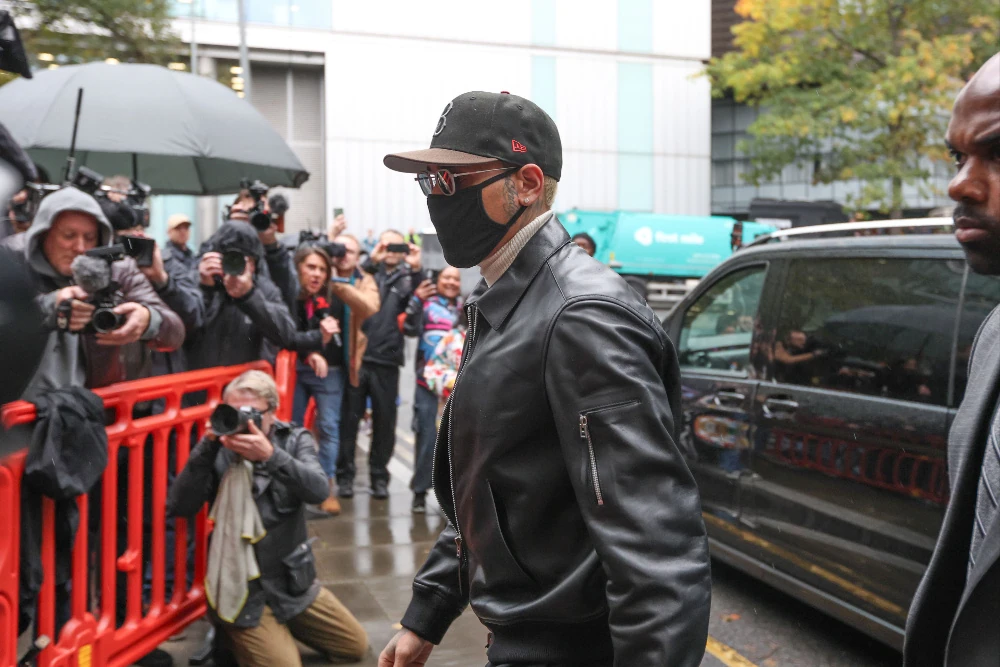 File photo: Chris Brown, wearing a face mask, walks past photographers
