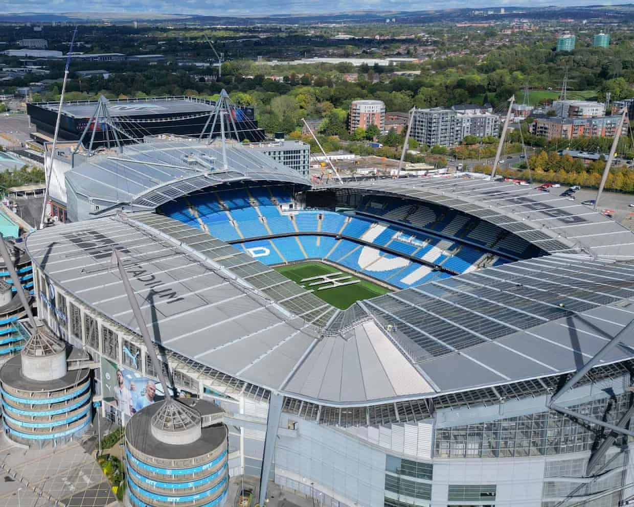An aerial view of the Etihad Stadium, illustrating the football-regulator report.