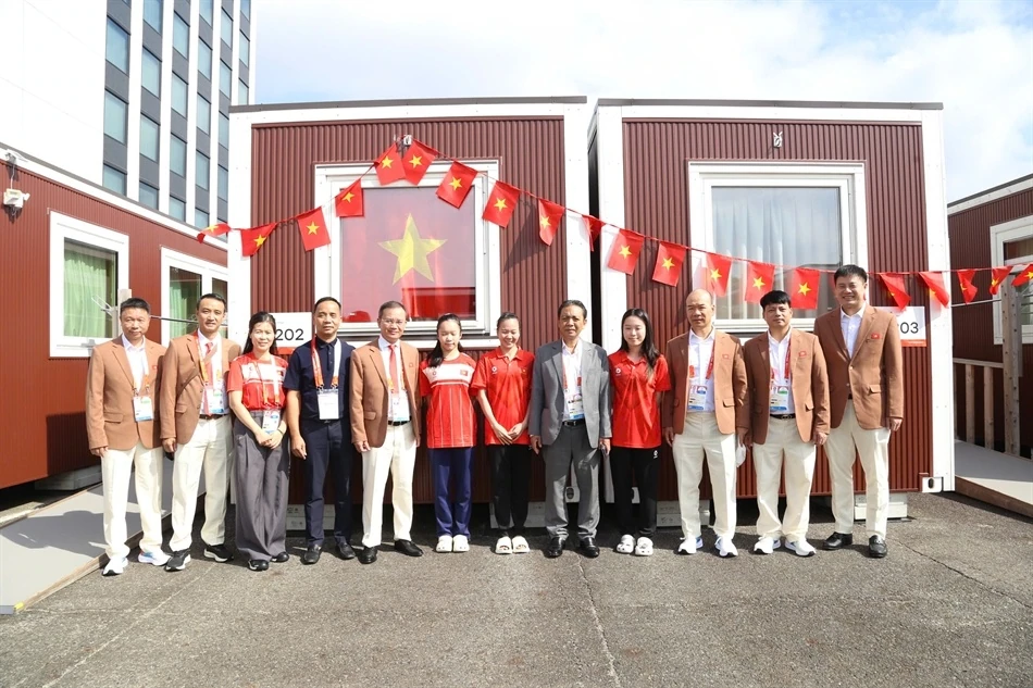 Members of Vietnam's sports delegation stand outside the container area at Athletes' Plaza.